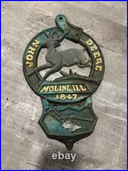 This is a vintage cast iron John Deere letter or match holder from Moline