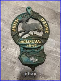 This is a vintage cast iron John Deere letter or match holder from Moline