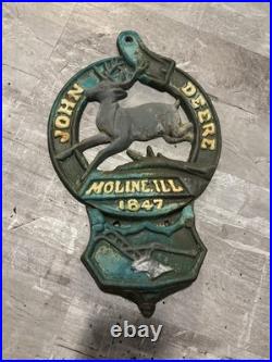 This is a vintage cast iron John Deere letter or match holder from Moline