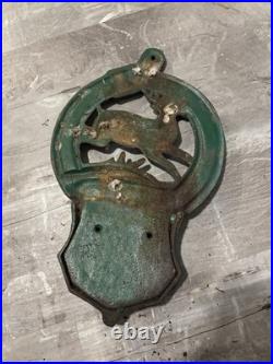This is a vintage cast iron John Deere letter or match holder from Moline