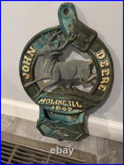 This is a vintage cast iron John Deere letter or match holder from Moline