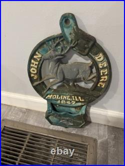 This is a vintage cast iron John Deere letter or match holder from Moline